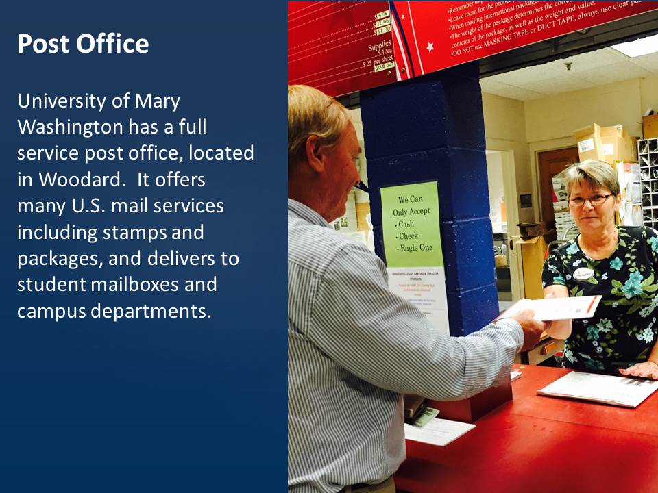 A Post Office employee accepts an envelope from a customer.