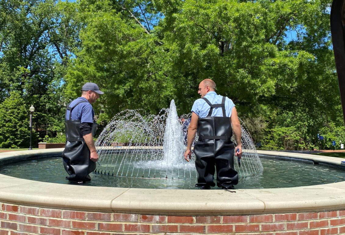 Plumbers working on a water fountain